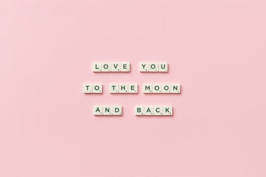 Letter tiles spelling 'Love You to the Moon and Back' on a pink background.