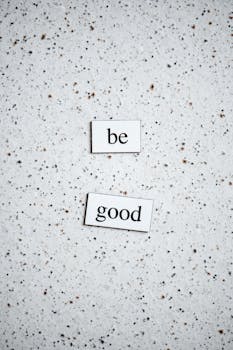 Minimalistic 'Be Good' message on a speckled surface providing positive inspiration.