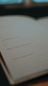 A close-up of an open journal featuring gratitude and reflection prompts, ideal for mental health mindfulness.