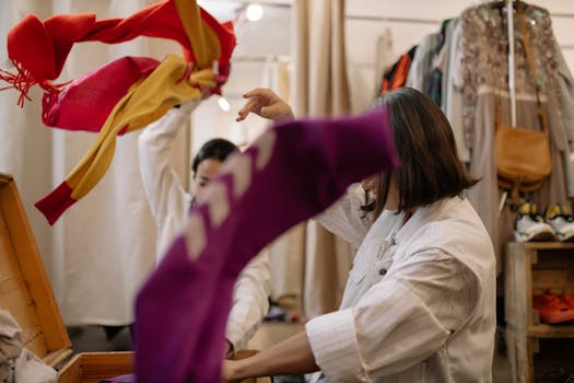 Woman exploring thrift store clothing, showcasing vibrant fashion choices.