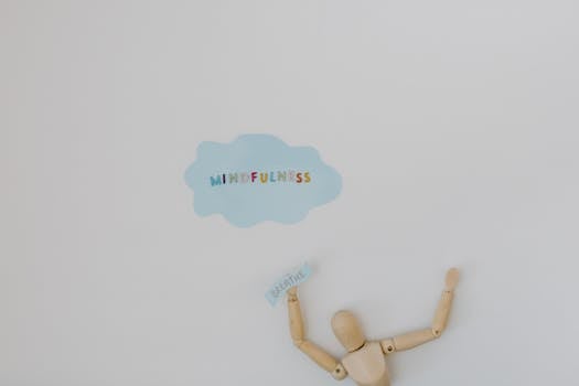 Wooden figure promoting mindfulness and breathing on a clean white background.